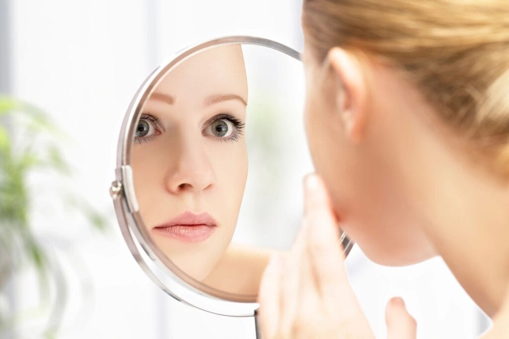 beautiful brides looking in a mirror