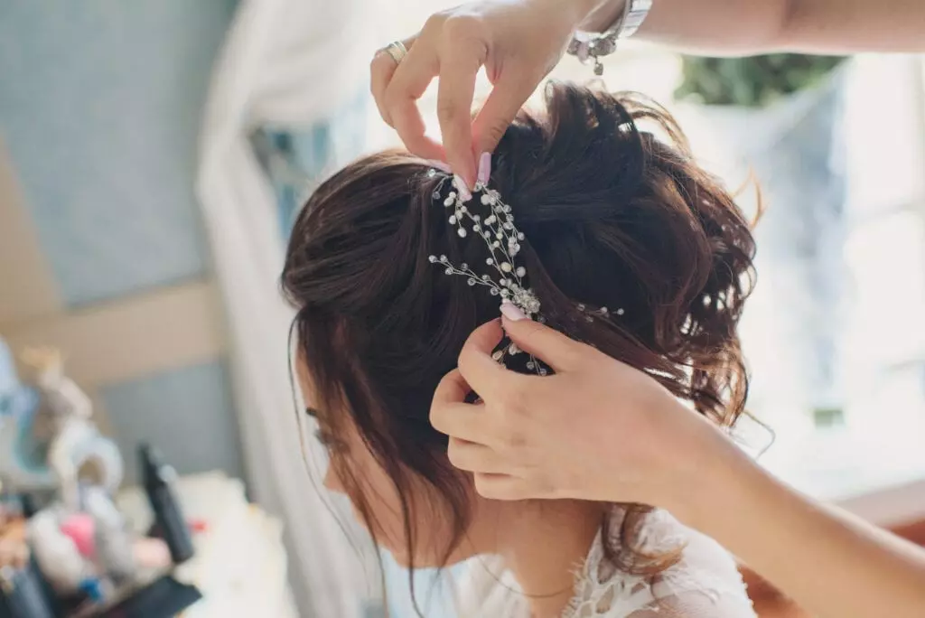 bride having her tiara adjusted at her trial