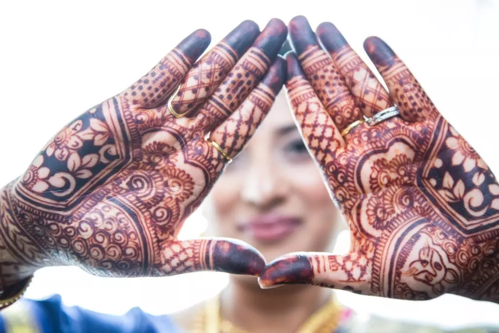 Hands full of henna tattoos