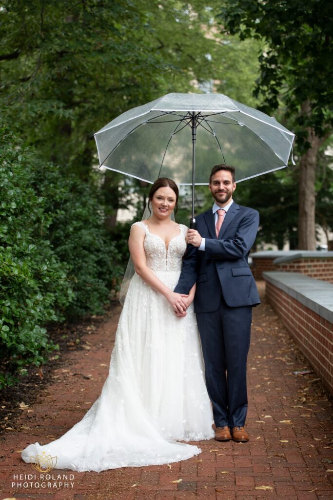 wedding couple with umbrella in philadelphia courtyard